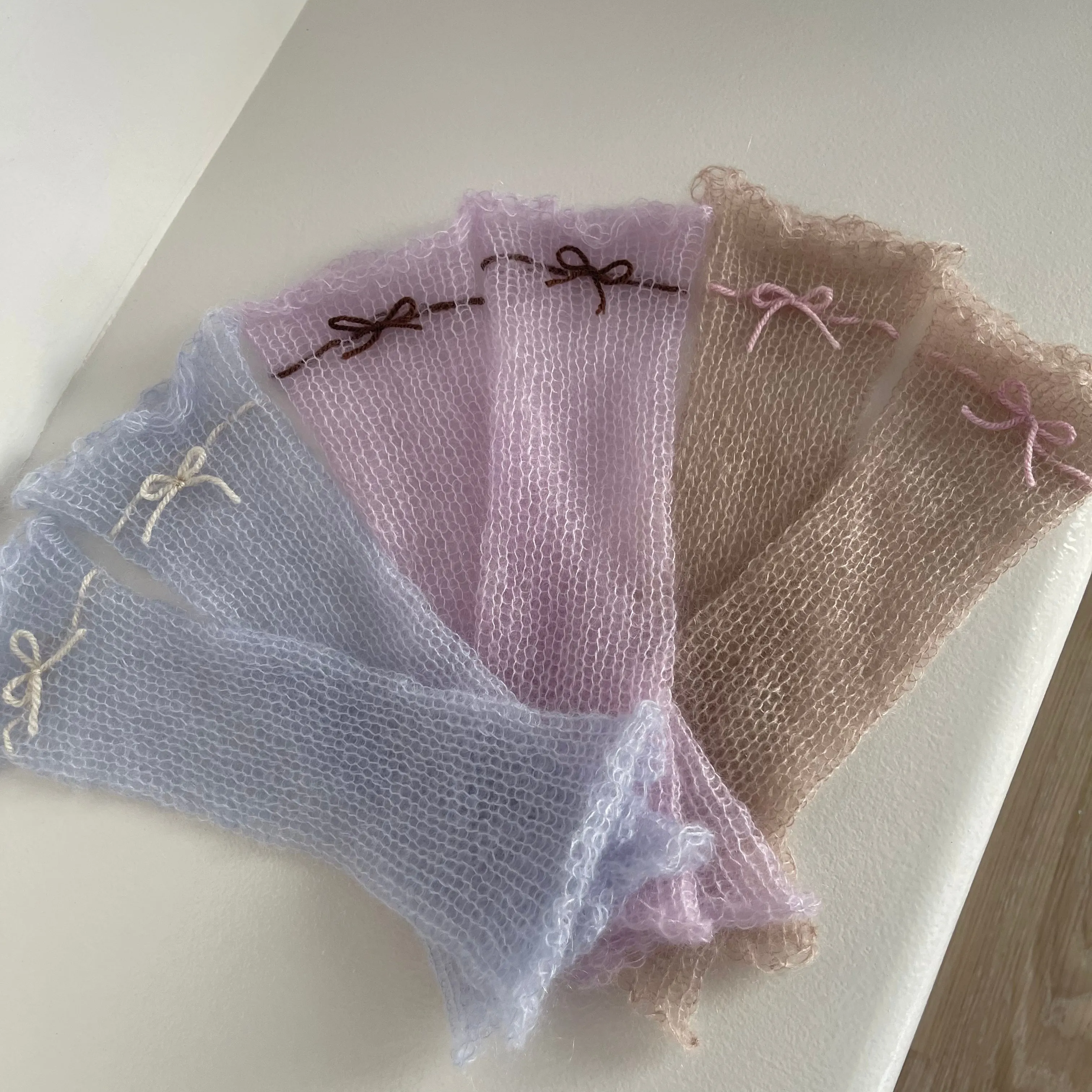 Handmade knitted mohair hand warmers in lilac with brown bow