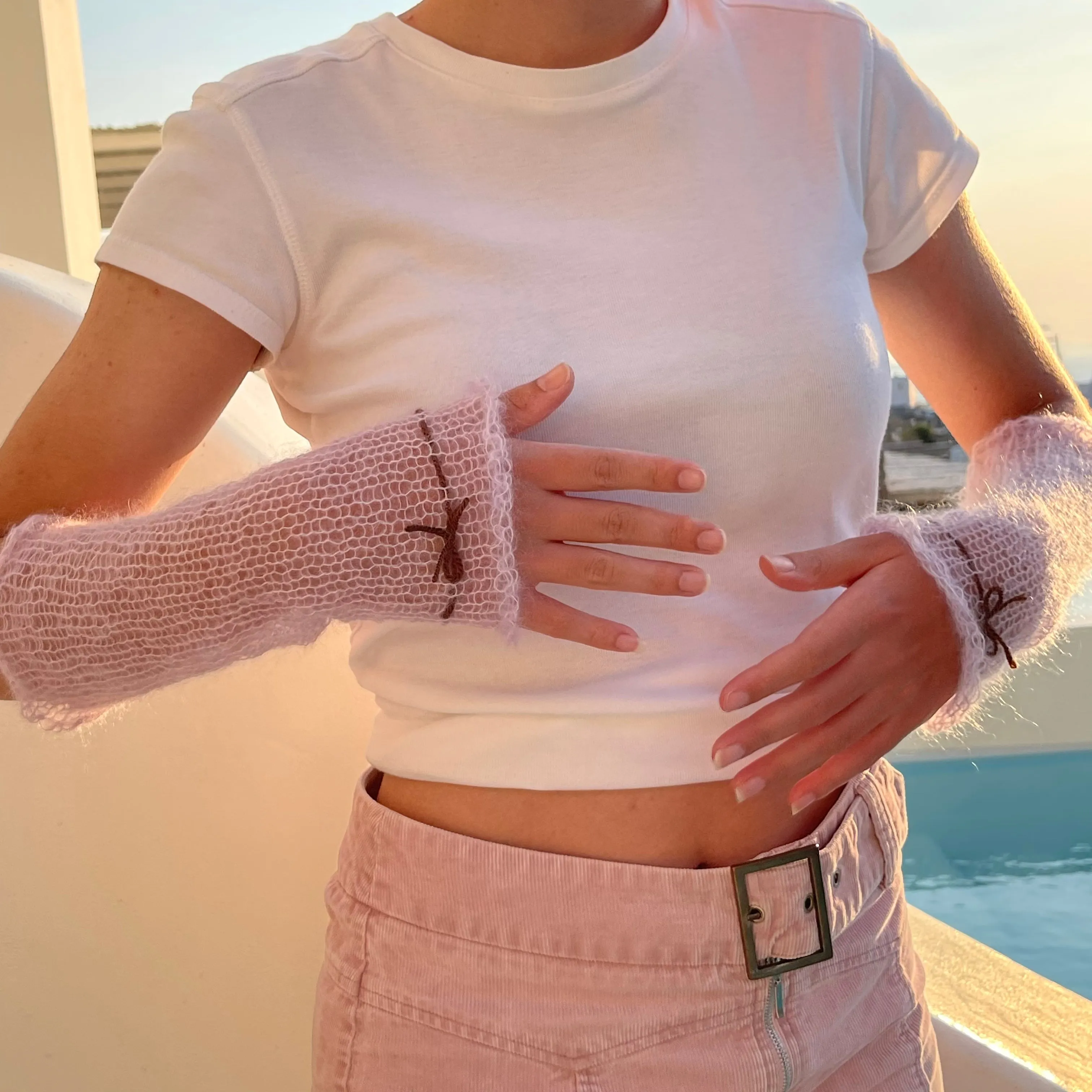 Handmade knitted mohair hand warmers in lilac with brown bow