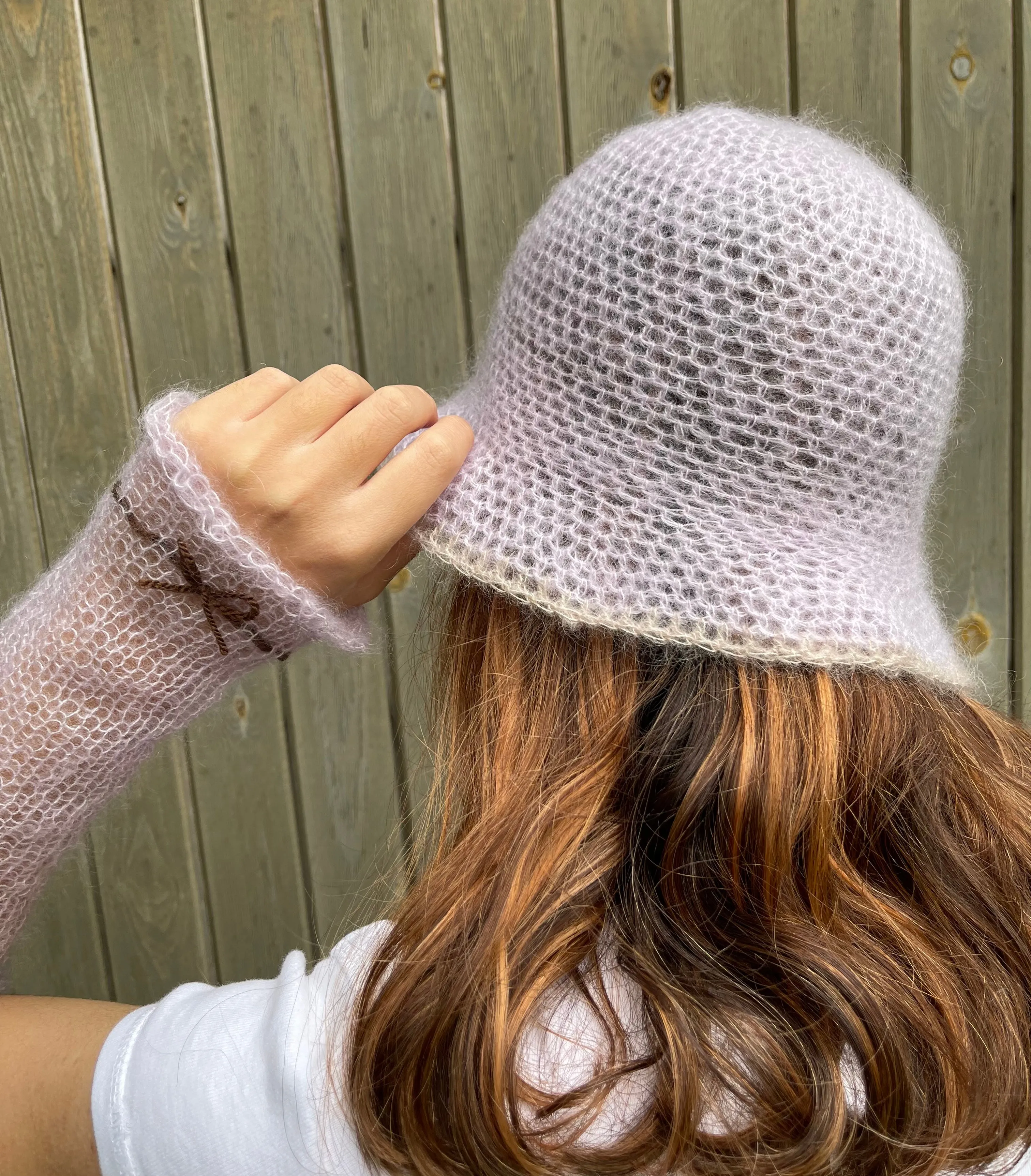 Handmade knitted mohair hand warmers in lilac with brown bow