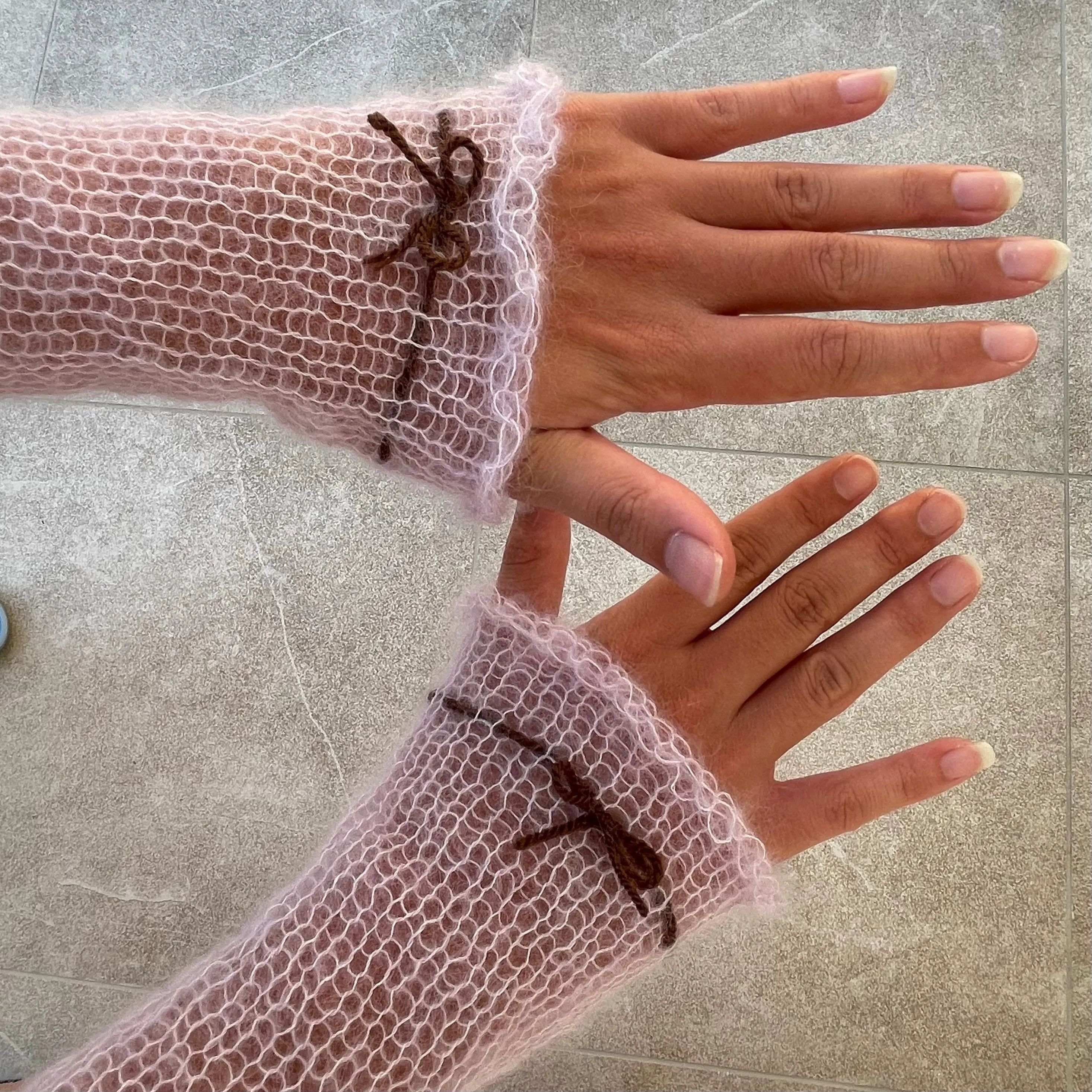 Handmade knitted mohair hand warmers in lilac with brown bow